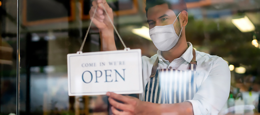 Stores Open at Level 2 Man with open sign in window