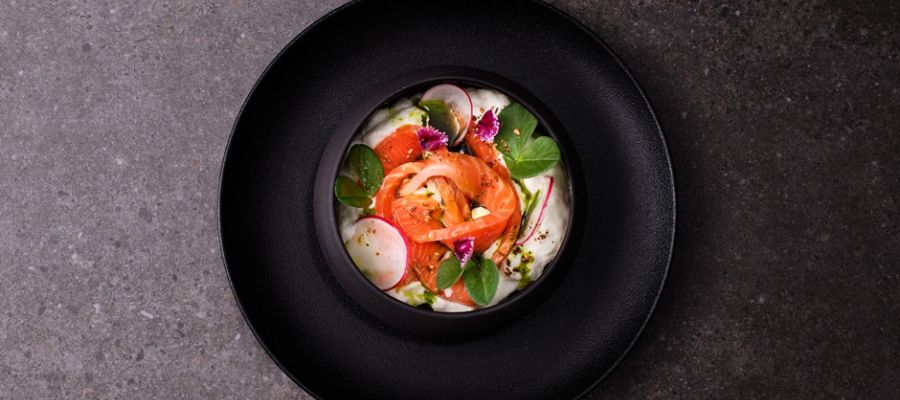 Cold Smoked Gin and Myer Lemon king salmon with a Goats cheese Cloud, Lemon Verbena and pistachio