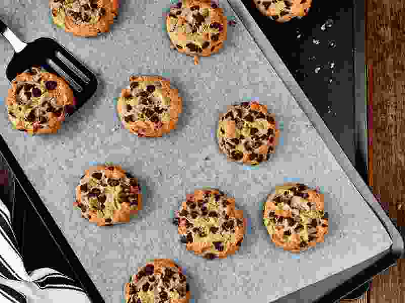 Freshly baked cookies on a commercial baking tray with non-stick baking liner