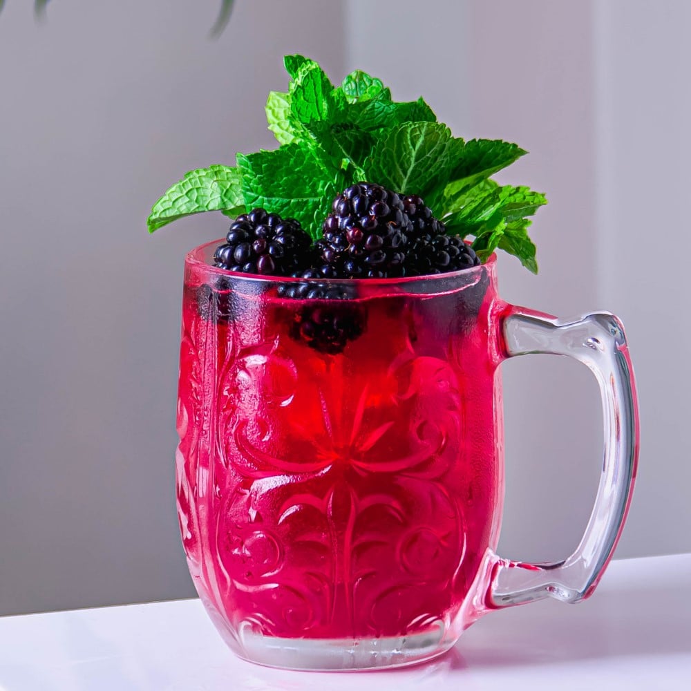 berry mocktail in a mug with mint topping