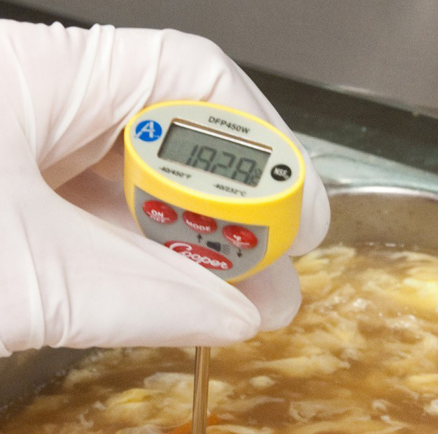 probe thermometer checking soup temperature