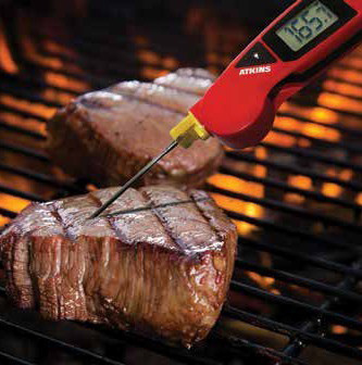 probe thermometer in steak on bbq
