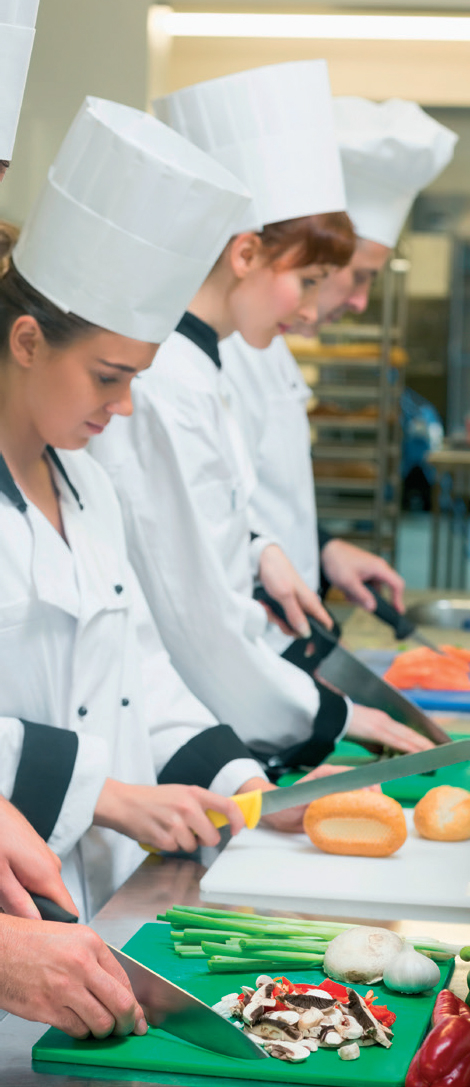 Young chefs prepping with chef hats