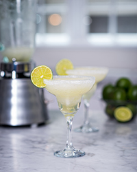 margerita in glass with lime and blender